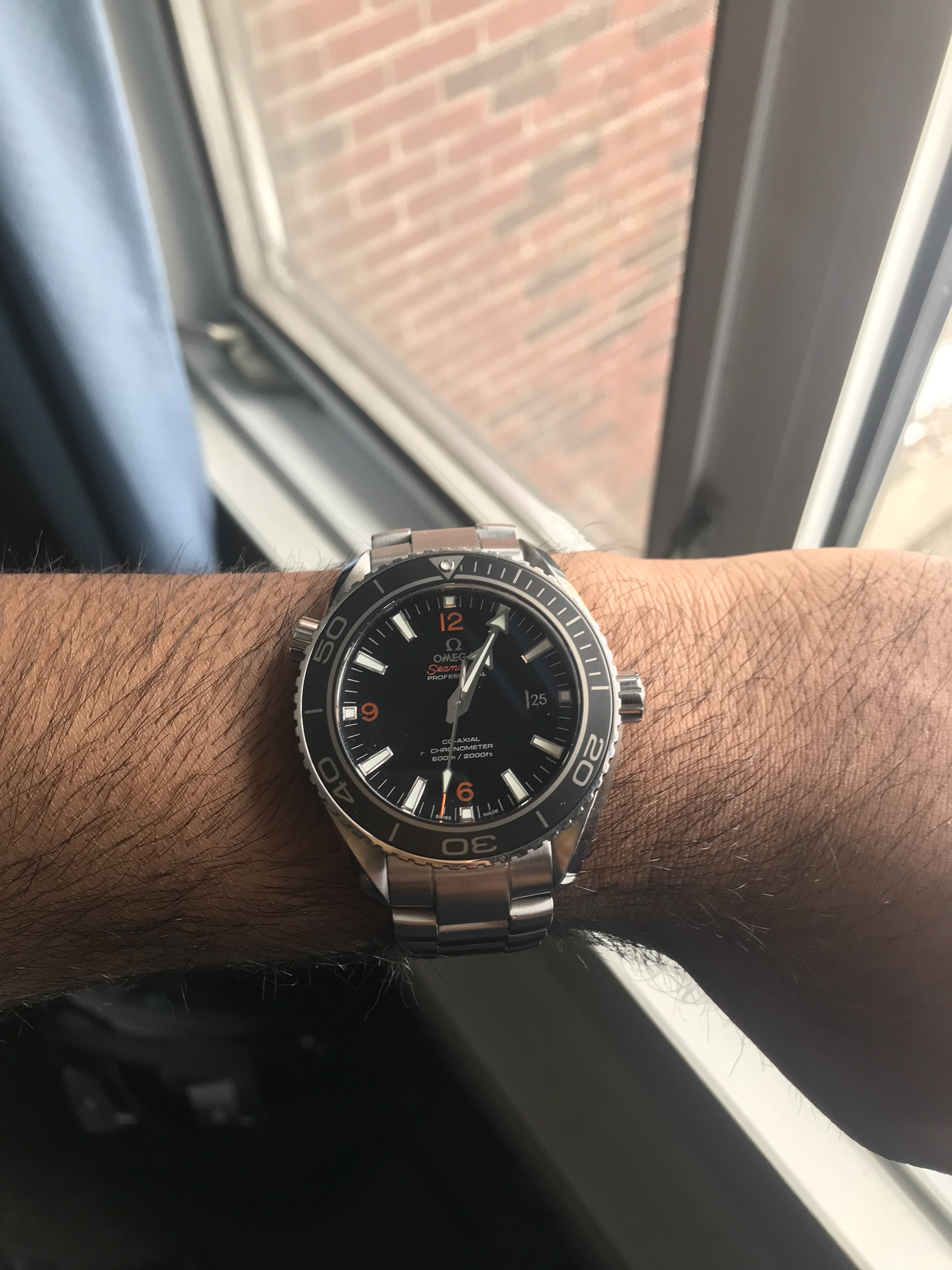 omega seamaster planet ocean on wrist